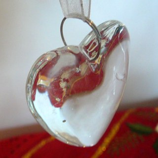 Glass heart reflecting light and absorbing colour